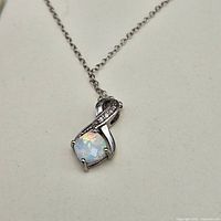 Close-up of opal pendant on chain