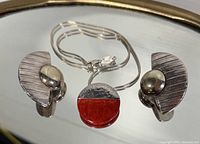 Necklace and earrings laid out showing overall design