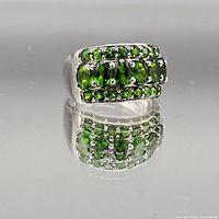 Front view of sterling silver ring with green stones