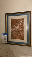 Front view of framed linocut print with maxsold tag