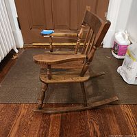 Side profile of wooden child rocking chair