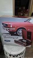 Front of sealed retail box showing product image and Ford Mustang branding