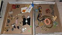 Overview of two trays of assorted costume jewelry