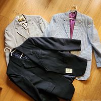 Three jackets displayed on floor showing colors and styles