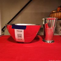 Square stainless steel bowl and hammered vase on display