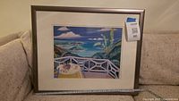 Overall view of framed tropical scene print on sofa