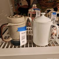 Both teapots side by side on shelf