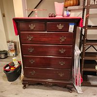 Full view of six-drawer dresser with hardware and feet visible