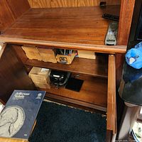 Open lower cupboard showing interior storage and wooden construction