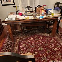 Rectangular wood table with parquet top, chairs around