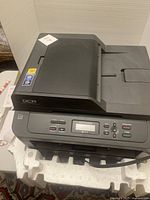 Top view showing Brother DCP printer on foam packaging