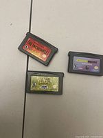 Three Game Boy Advance cartridges laid out
