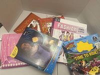 Top view of pile showing all books, binder and Mickey book