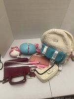 Overall lot showing backpack, two bags, plush toys, egg, brush, wands