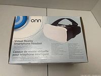 Front of boxed Onn VR headset showing product image and specifications