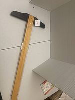 Full length view of one wooden T-square showing shaft and crosshead