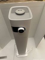 Full view of humidifier standing upright with power cord