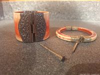 Wide cuff and slim bangle with pins displayed