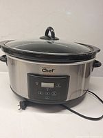 Front view of Master Chef slow cooker showing stainless body, glass lid and cord
