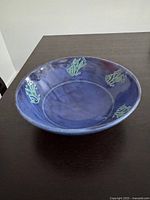 Side profile of blue pottery bowl on dark table