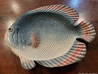 Front view of fish-shaped Fitz and Floyd platter showing coloration and molded detail
