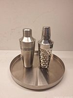 Front view of tray and both shakers standing upright