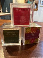 Three acrylic cube TableTopics games: Original, Seventies, Sixties