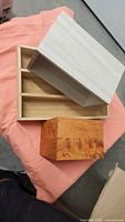 Light wood box open showing 3-compartment insert and stained cube box