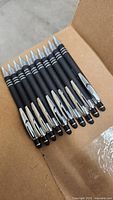 Group of black stylus pens in box
