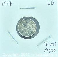 Reverse of 1914 threepence coin in 2x2 holder showing denomination and date