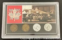 Front of plastic holder showing four coins and display title