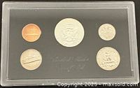 Obverse view of five proof coins in sealed plastic holder