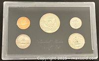 Obverse side of five proof coins in lucite holder