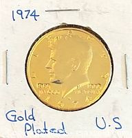 Obverse of 1974 gold-plated Kennedy Half Dollar in 2"×2" holder