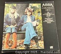 Front gatefold cover showing ABBA members on park bench