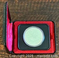 Coin in open red-lined case