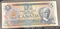 Obverse of 1979 Canadian $5 note showing portrait, coat of arms and denomination