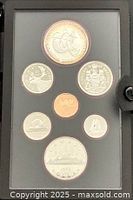 Display side showing seven proof coins in case
