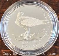 Reverse of coin showing Peregrine Falcon design in capsule