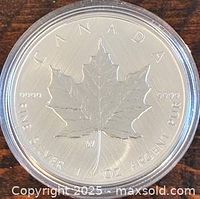 Reverse of 2021 Canadian Silver Maple Leaf showing maple leaf design, purity 9999 and W mint mark in capsule