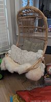 Full view of rattan egg chair with cushions