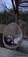 Off-white woven rattan hanging egg chair with cushions