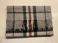 Folded plaid lambswool scarf showing fringe