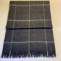 Full view of wool scarf folded showing pattern and fringe