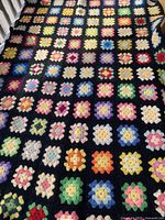 Full view of multicolour granny square wool throw