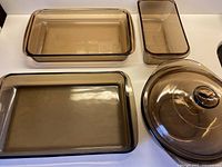 overhead view of all four smoky brown Pyrex pieces