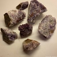 Seven amethyst clusters laid out showing overall lot