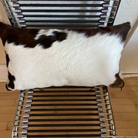 Front view of cowhide pillow showing cream dominant side