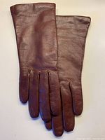 Top view of both gloves showing burgundy leather exterior