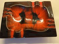 Top view of rectangular ashtray showing black glaze and red lava drip pattern